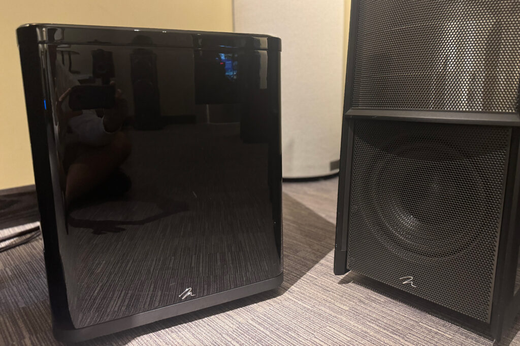 The MartinLogan BalancedForce 212 subwoofer parked next to some big MartinLogan ESL floorstanding speakers.