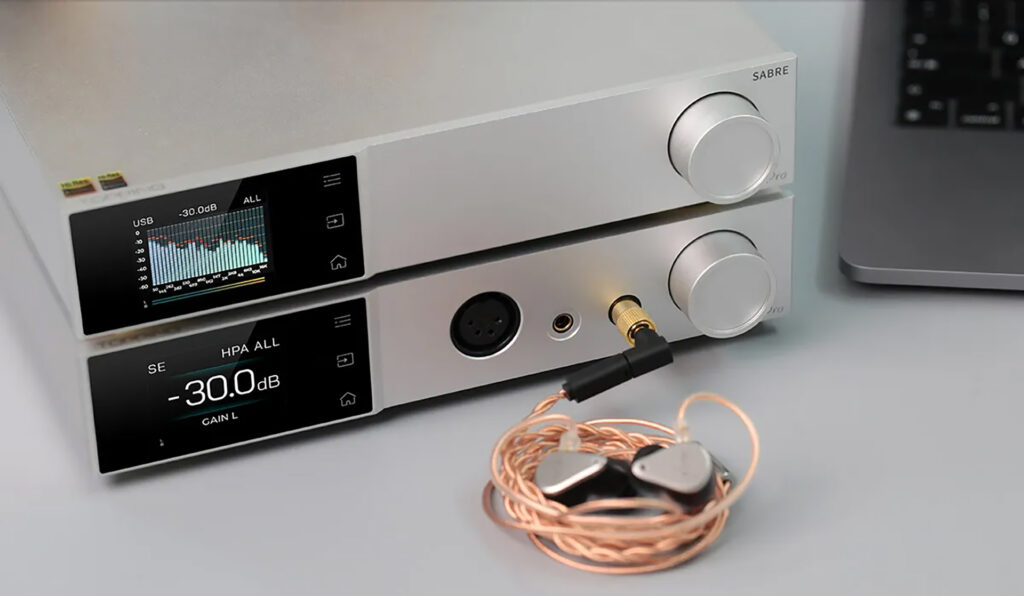 A stack of Topping electronics including some wired IEMs.