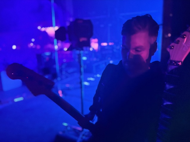 Uncle Johnny getting another guitar ready during the show.