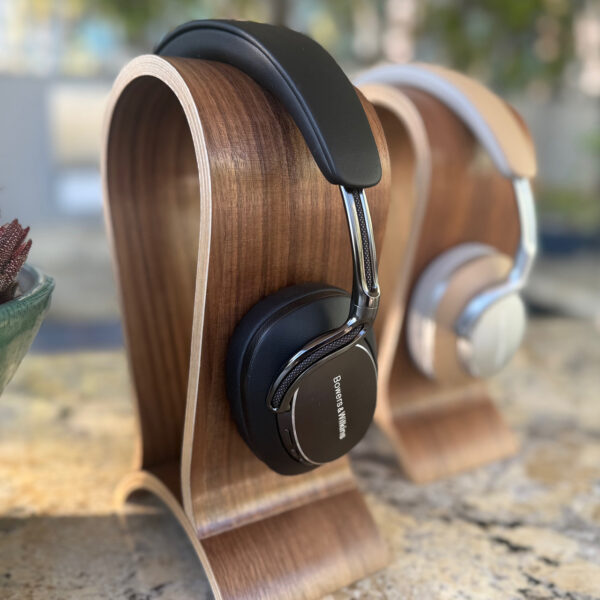 The Bowers & Wilkins Px8 S2 headphones on display (in black) with a pair of first gen headphones nearby.