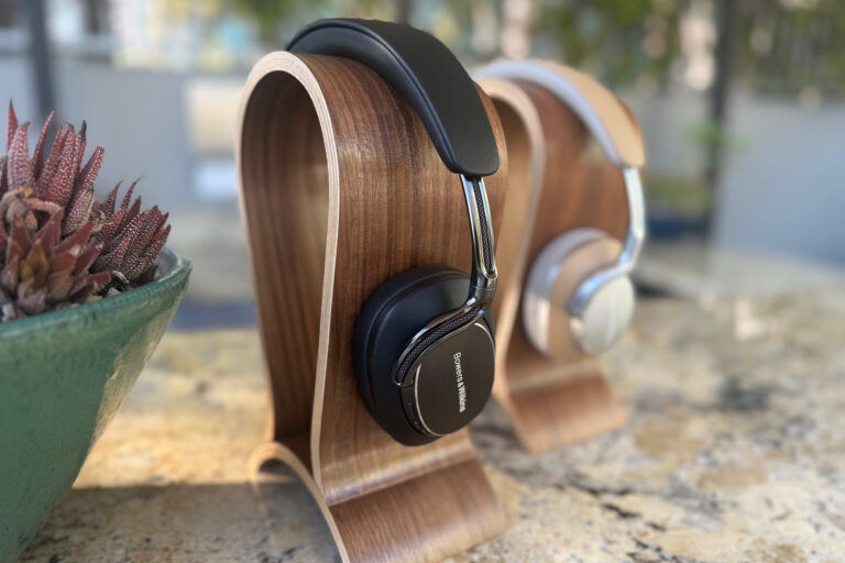 The Bowers & Wilkins Px8 S2 headphones on display (in black) with a pair of first gen headphones nearby.