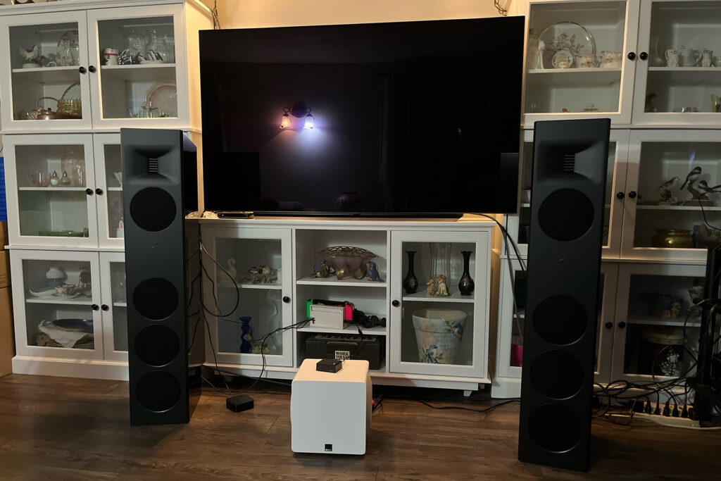 Putting speakers in front of glass is less than optimal but sometimes necessary. 