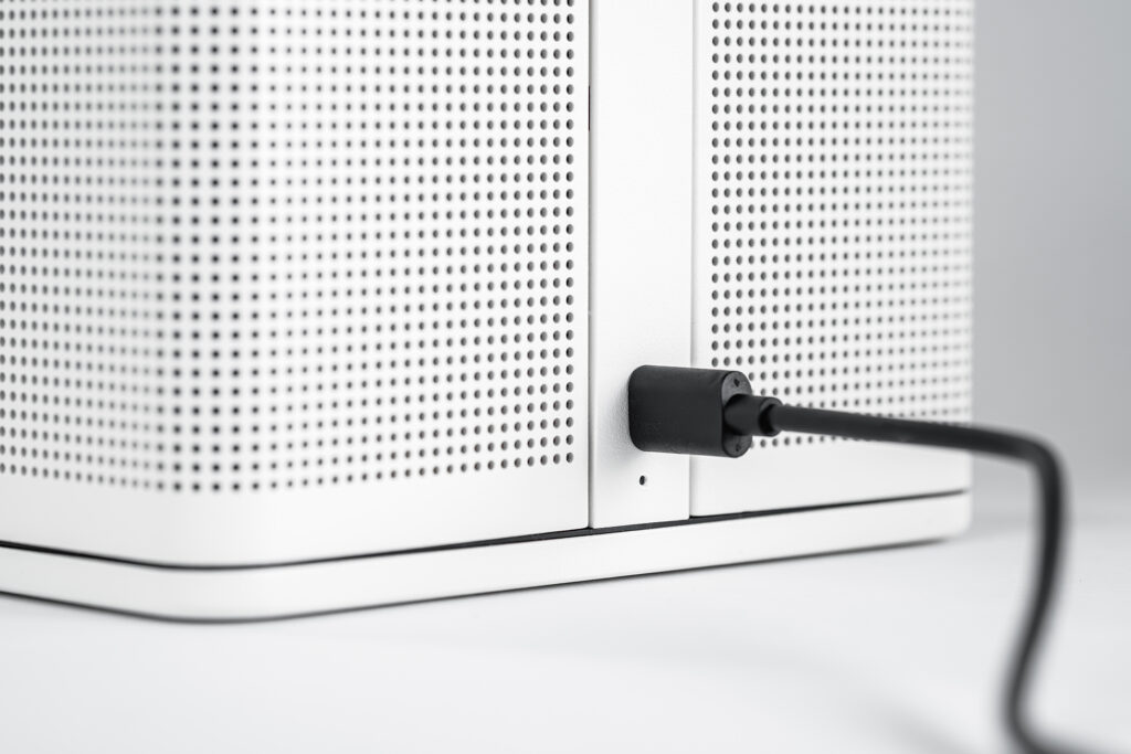 A Bluetooth cable connected to a Bluetooth speaker. Charging like an EV.