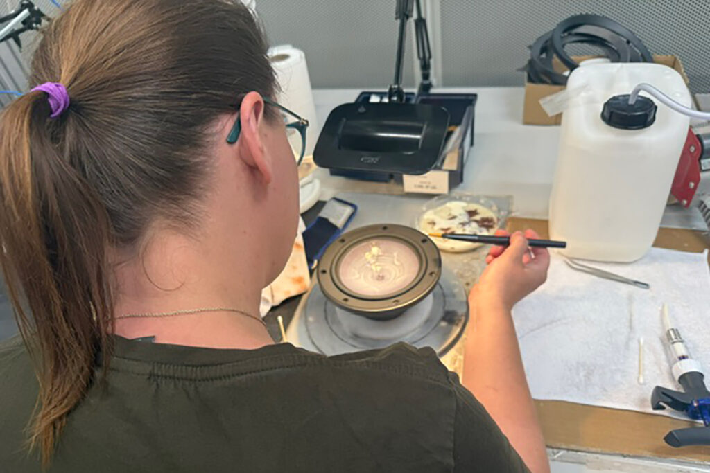 A coating goes on the handmade, iconic, paper drivers at Dali.